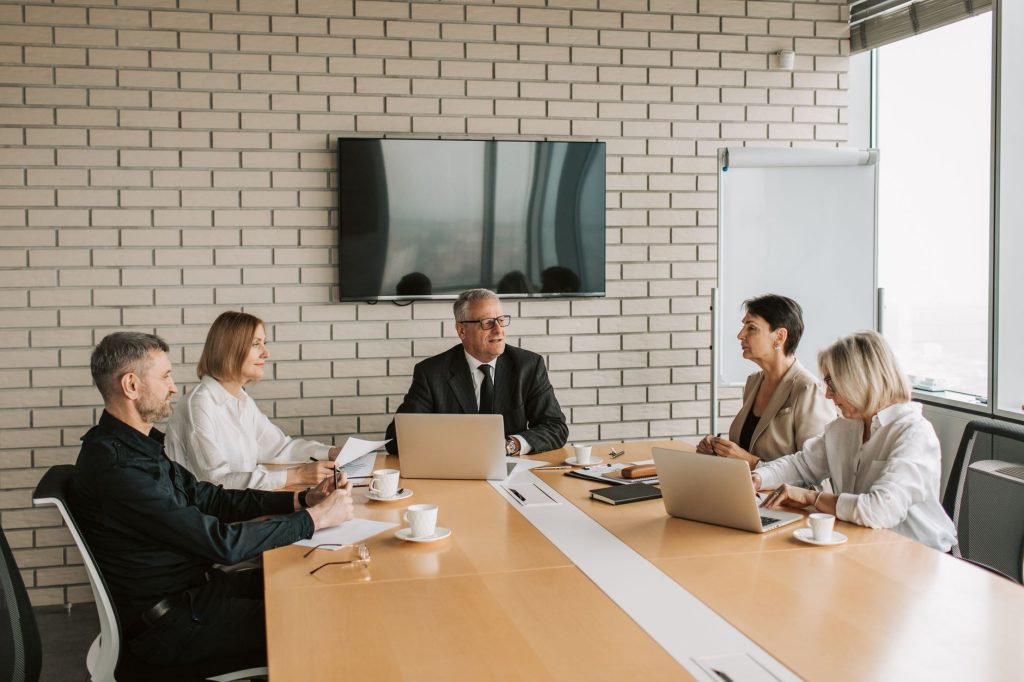 Professionals discussing software integration and data governance around a conference table.