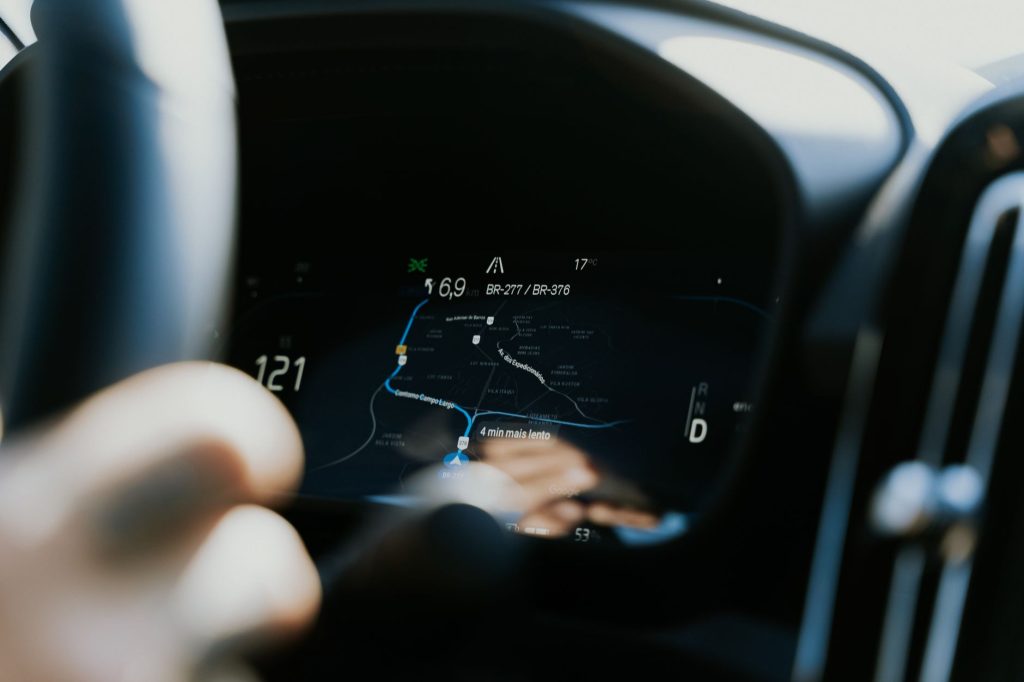 A navigation system compares alternative routes to reach a destination, illustrating how a goal-based agent plans toward a goal.