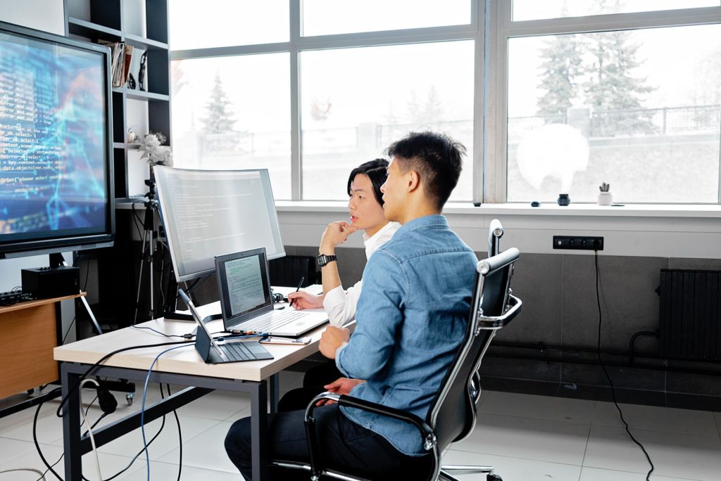 Colleagues review data and connected systems while planning responsible AI adoption.