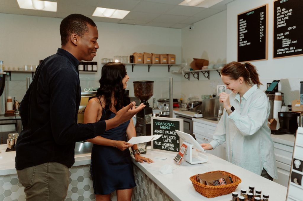 Restaurant staff serving guests while an AI assistant handles routine bookings and questions.