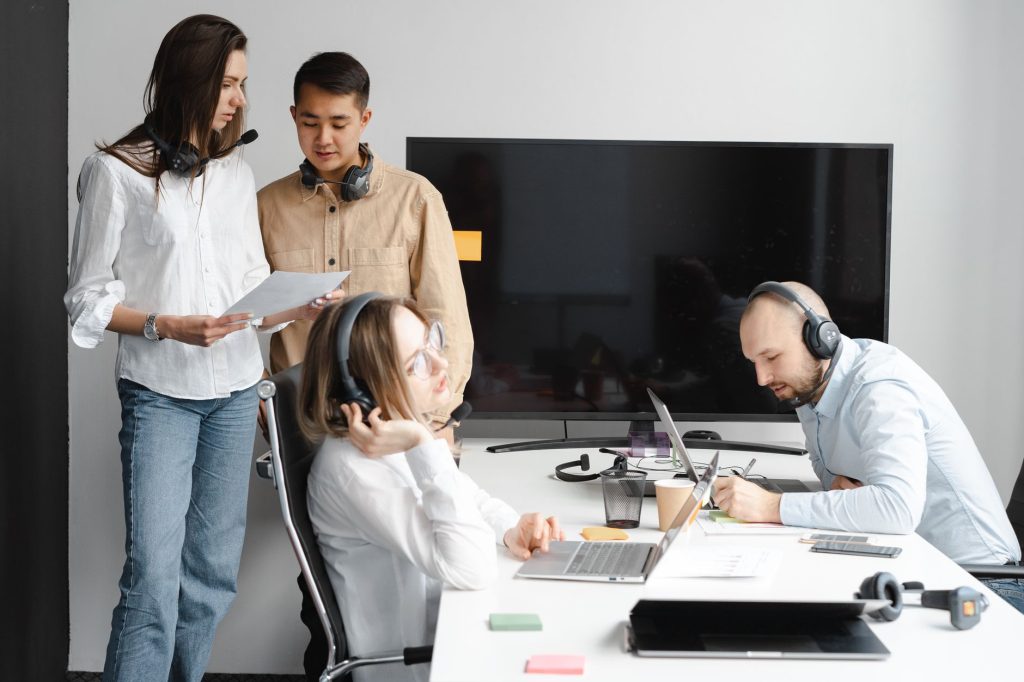 Team members reviewing documents together at a shared workstation